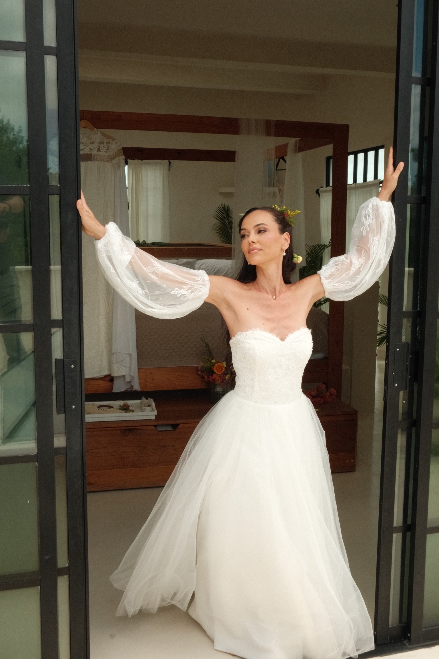 Bride at the open doors of her getting-ready room at Rancho Verde