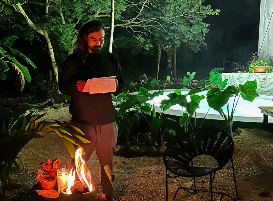 coach reflecting in the jungle over the campfire at Rancho Verde Tulum