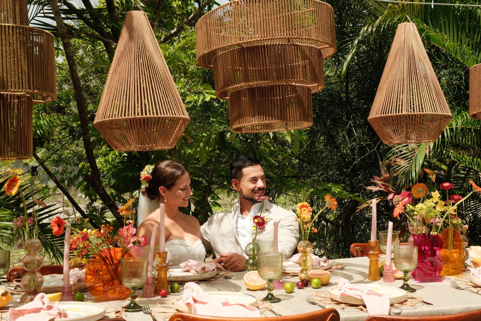 Couple at their decorated wedding dinner table in the jungle at Rancho Verde