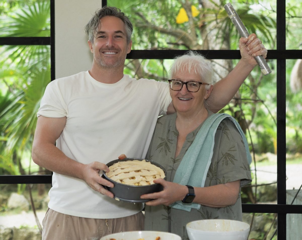 Thomas and his mother with a homemade apple pie, plant-based cooking at Rancho Verde Tulum