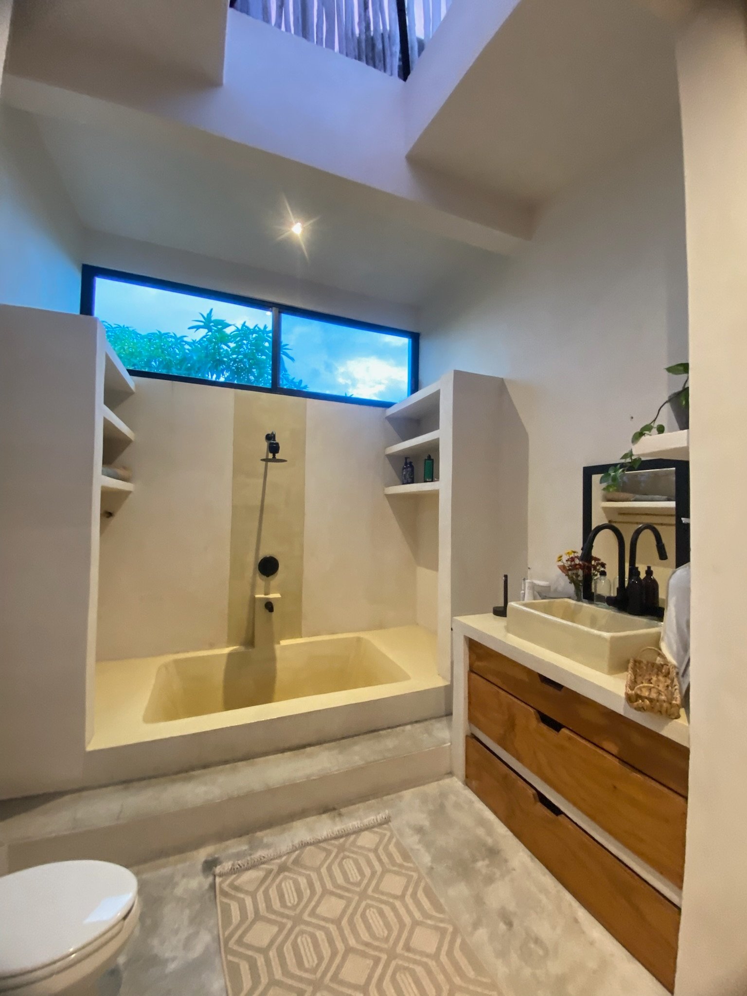 Casa Blanca bathroom with a built-in concrete tub and wooden-drawer vanity, Rancho Verde Tulum, Tulum, Mexico