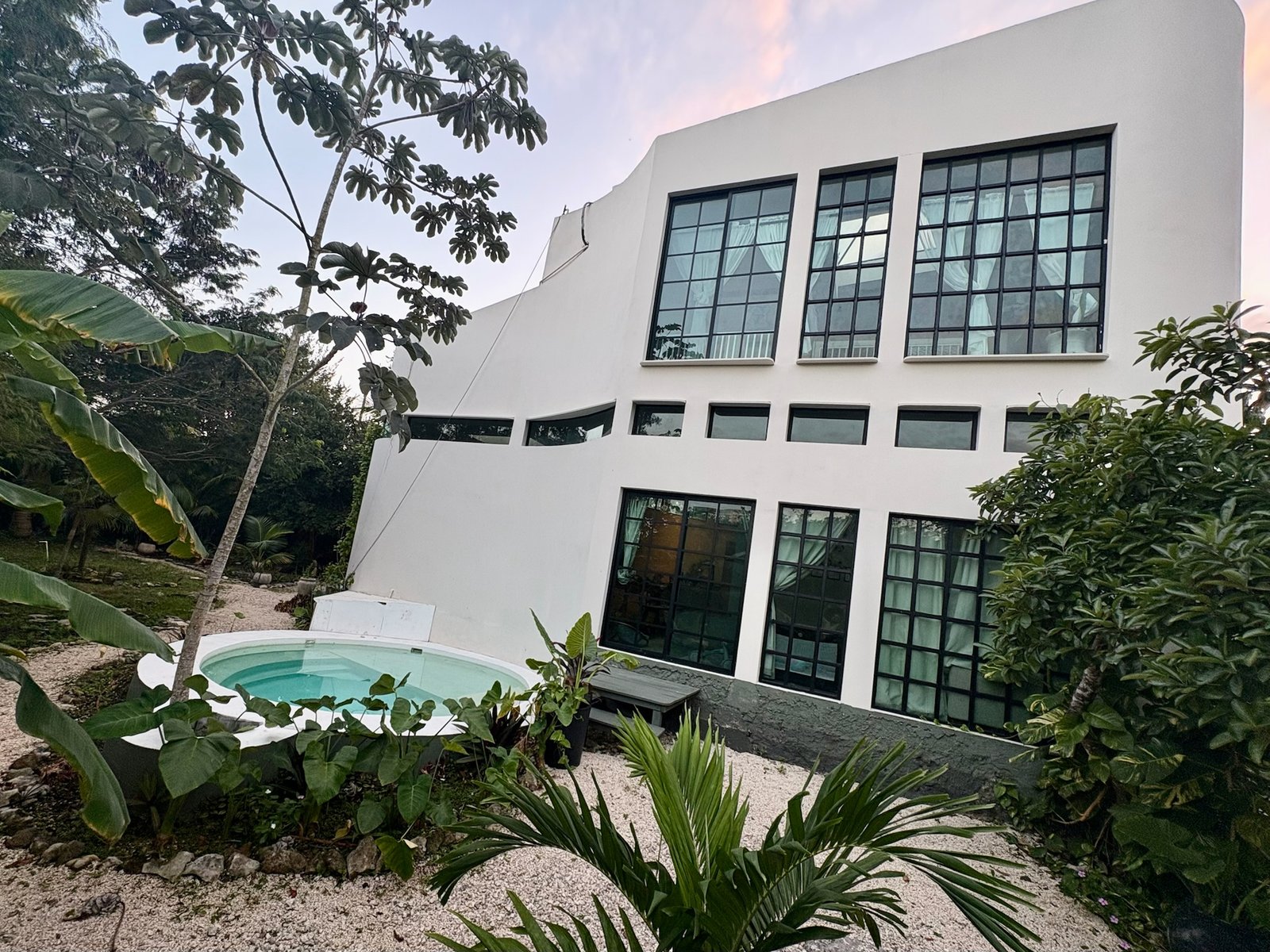 Finished Casa Blanca with its round plunge pool at dusk, Rancho Verde Tulum, Tulum, Mexico