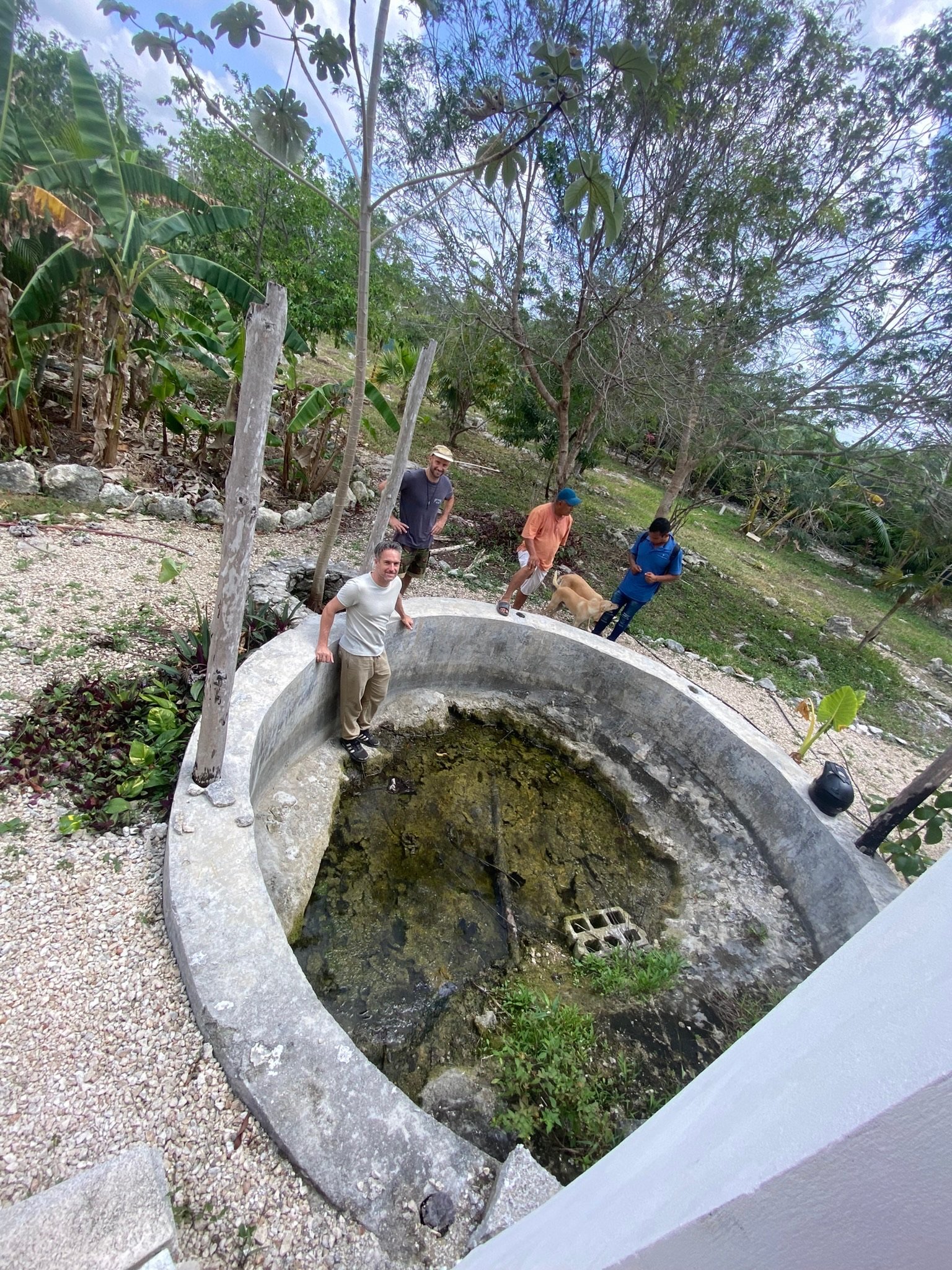 Crew and founders on a site visit at the concrete cistern, Rancho Verde Tulum, Tulum, Mexico