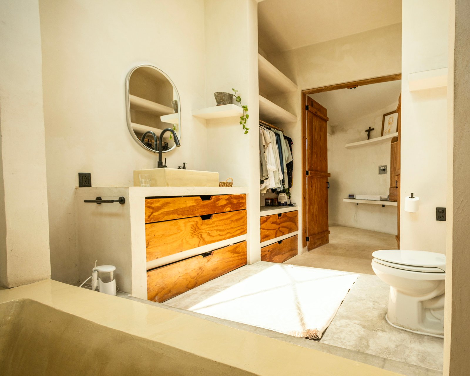 Bathroom vanity with hand-built wooden drawers set into a concrete frame, Rancho Verde Tulum, Tulum, Mexico