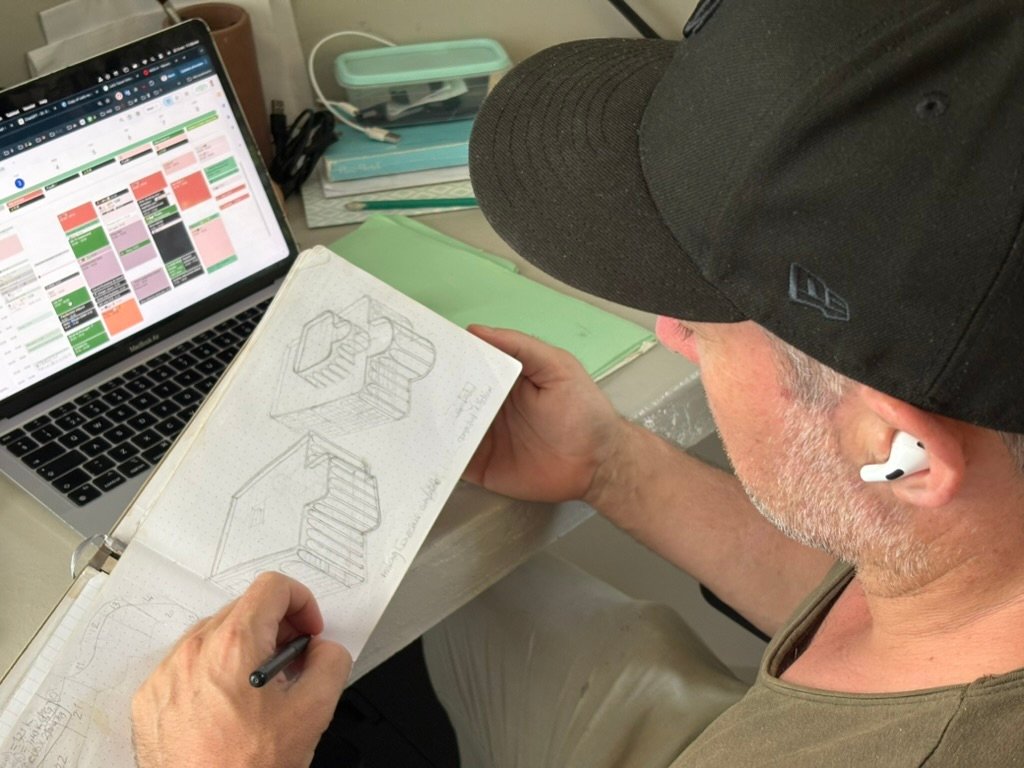 Founder Thomas drawing a staircase by hand at his desk, Rancho Verde Tulum, Tulum, Mexico