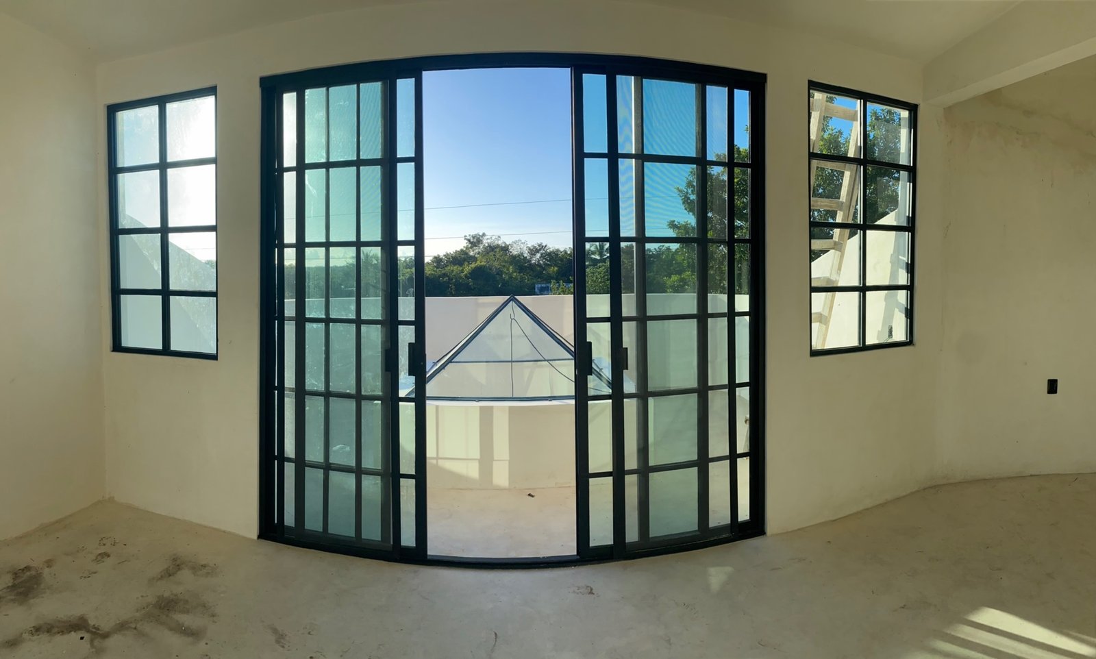 View through arched doors to the finished pyramid roof window on the terrace, Rancho Verde Tulum, Tulum, Mexico