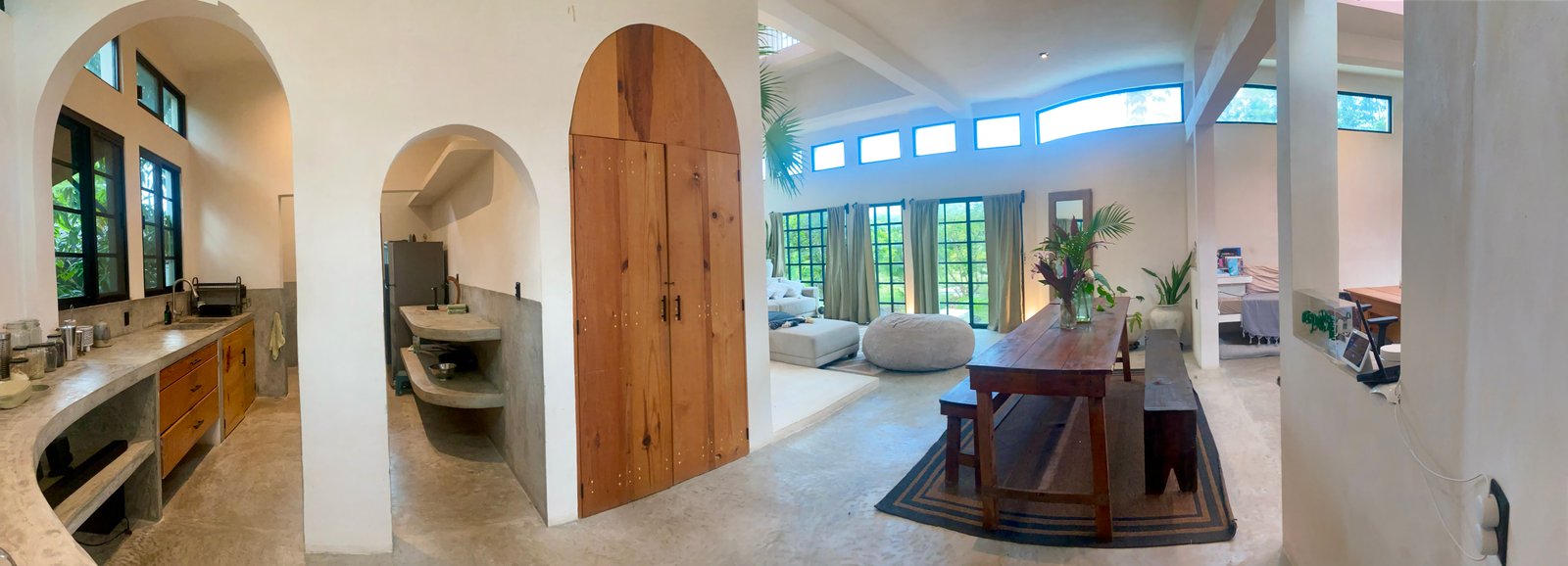 Casa Blanca kitchen with arched openings and concrete counters, Rancho Verde Tulum, Tulum, Mexico