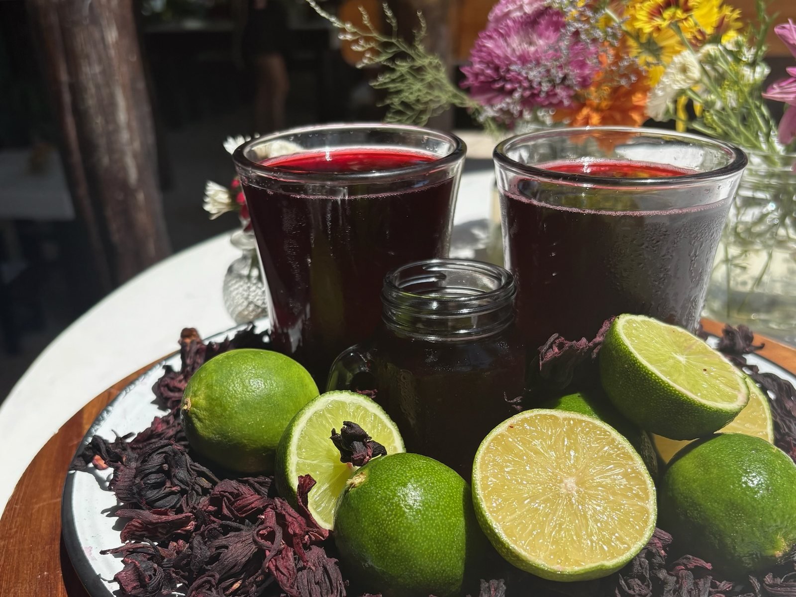 Hibiscus agua fresca with fresh limes and dried jamaica flowers, vegan event catering by Liefs Tulum at Rancho Verde