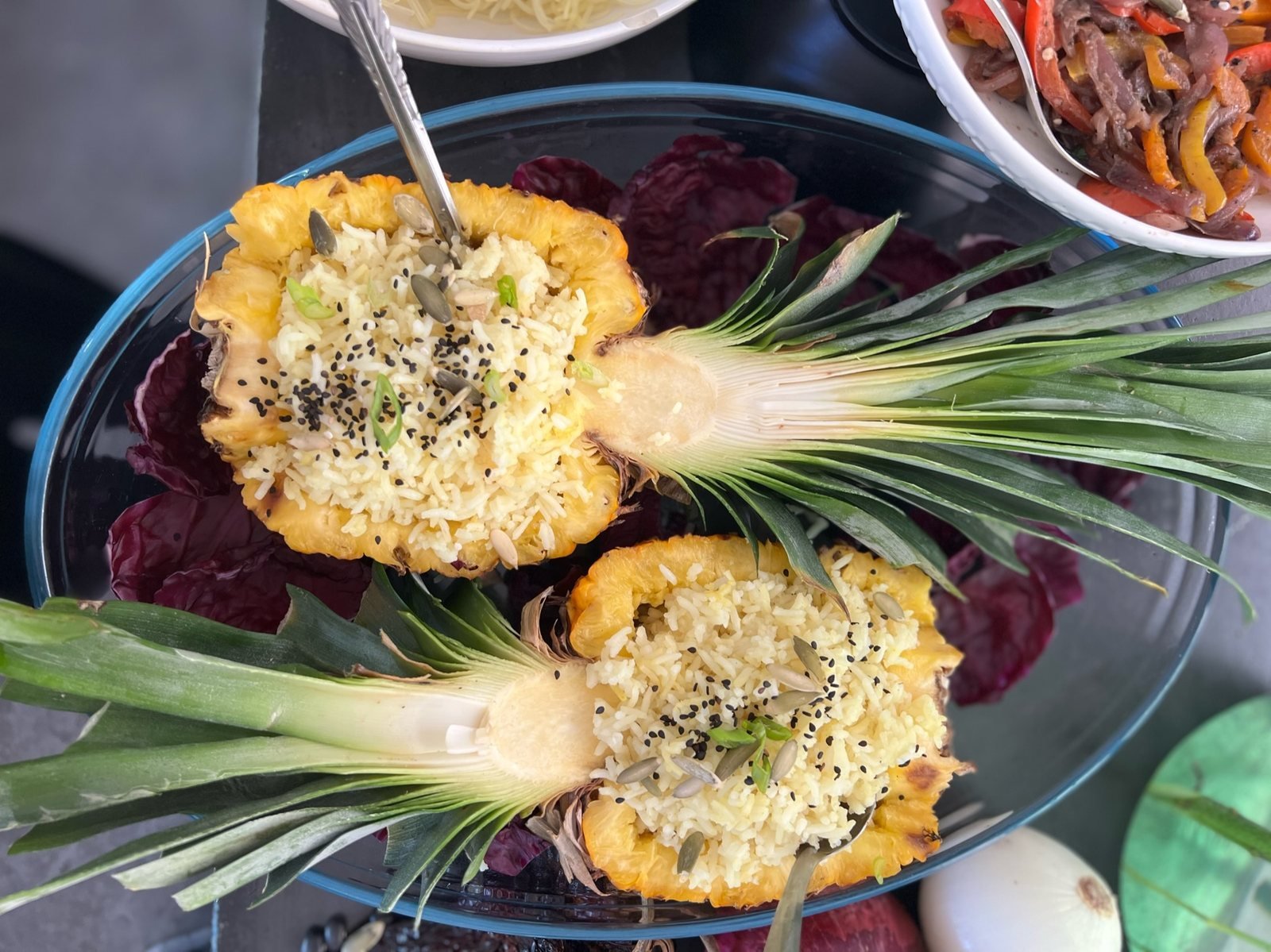 Pineapple boats filled with coconut rice, pumpkin seeds and black sesame, vegan event catering by Liefs Tulum at Rancho Verde