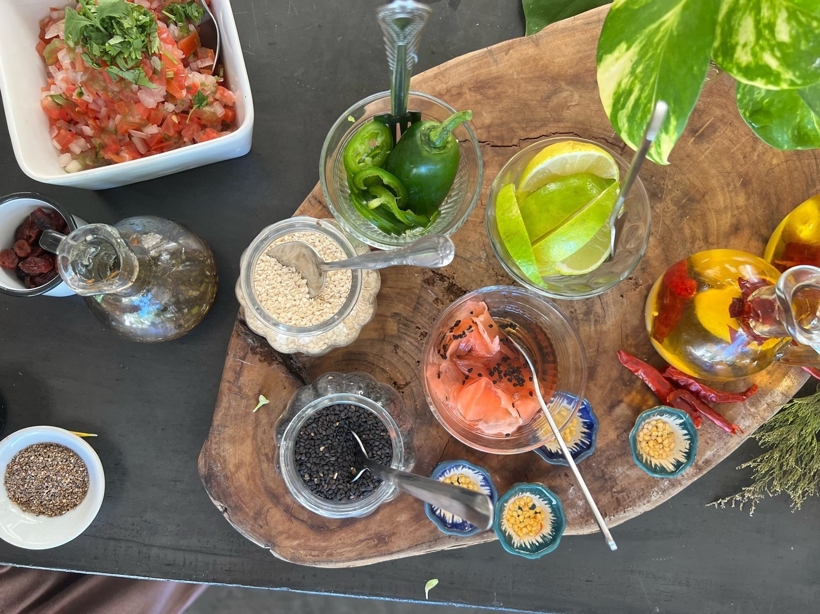 Toppings board with limes, jalapeño, pickled ginger, sesame seeds and chili oil, vegan event catering by Liefs Tulum at Rancho Verde