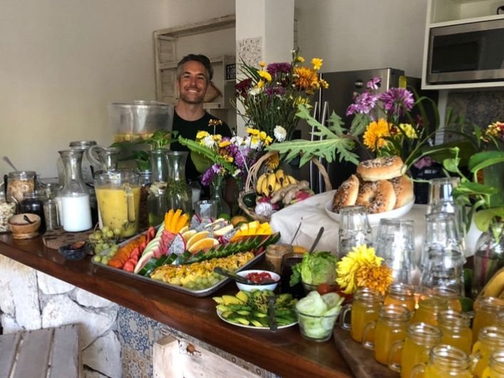 Liefs Tulum breakfast bar with fresh juices, fruit, bagels and flowers for a group