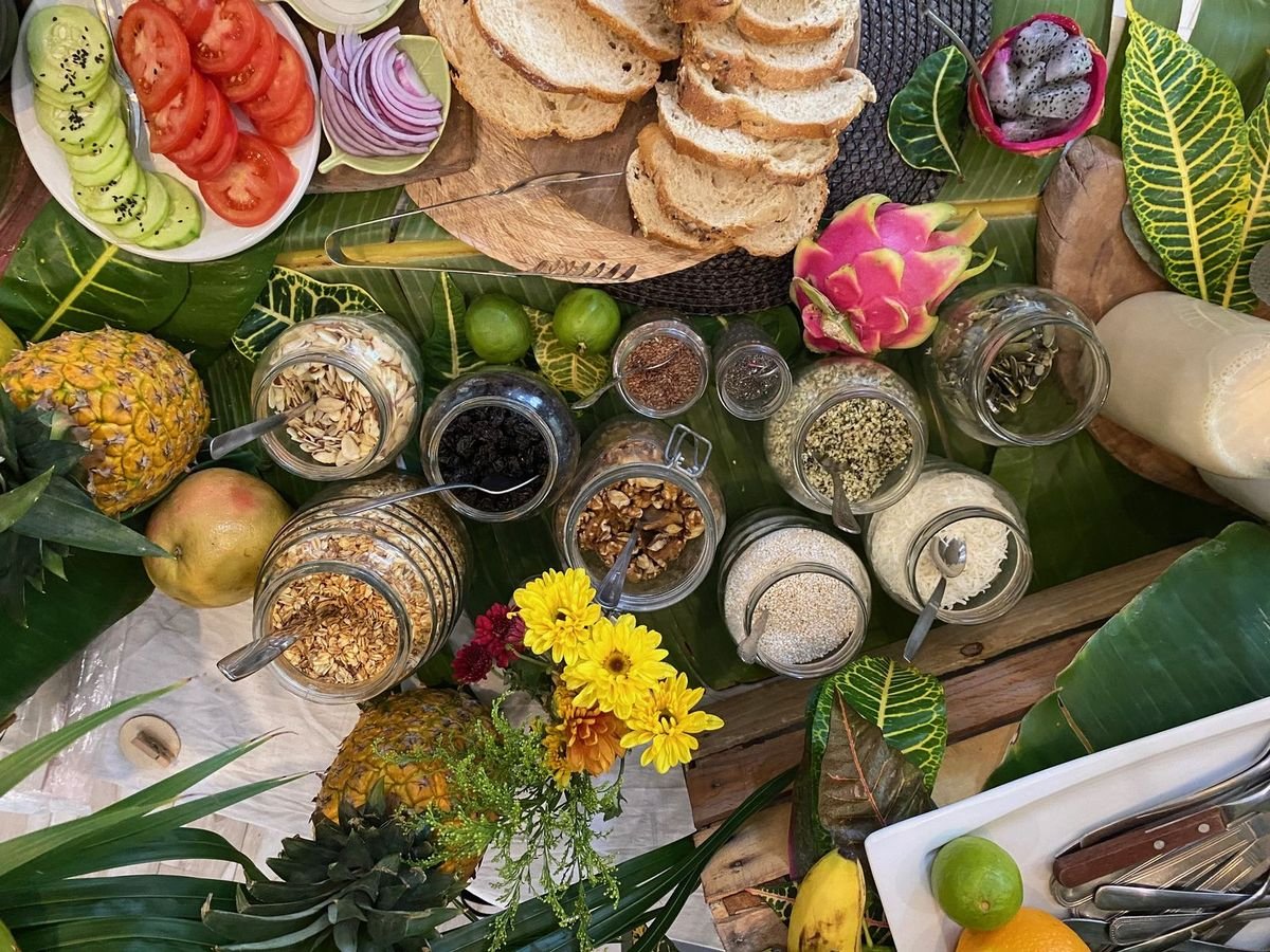 Zero-waste vegan breakfast toppings in glass jars: granola, nuts, seeds and fresh fruit by Liefs Tulum