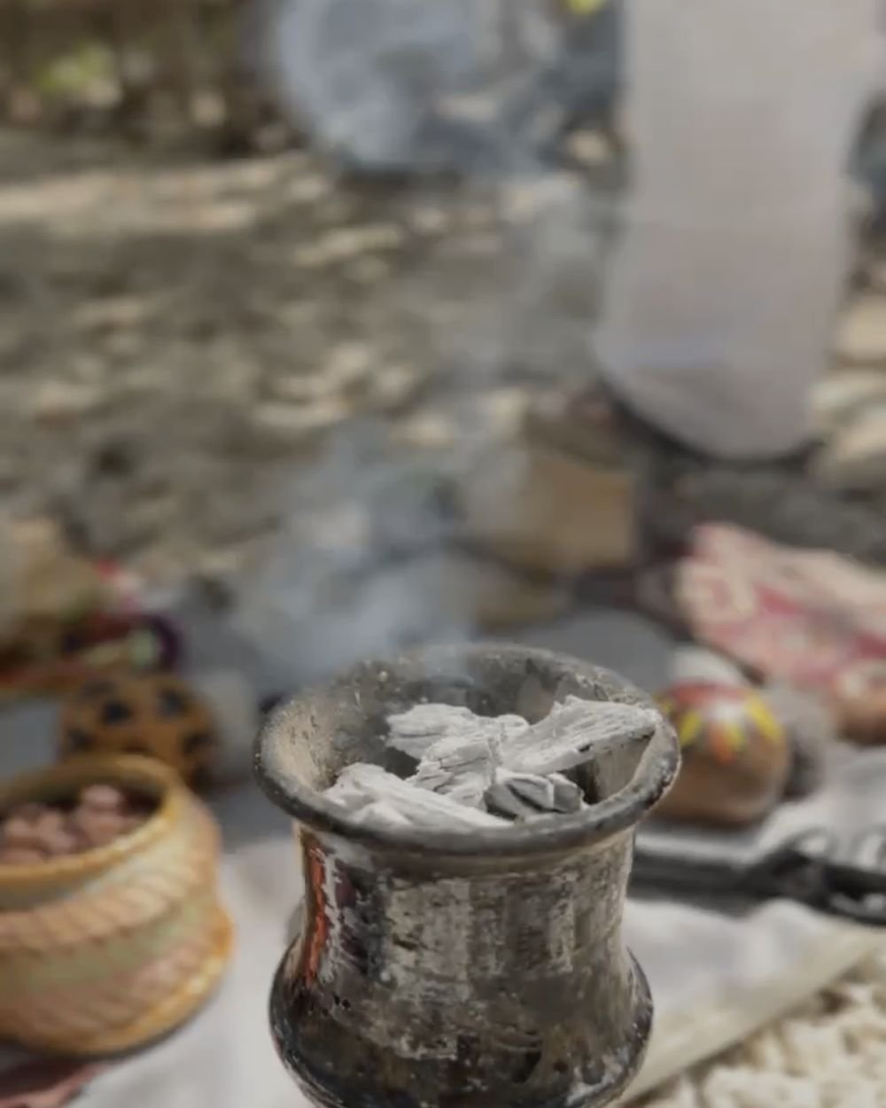 Copal incense burning in a clay censer during a traditional ceremony in Tulum