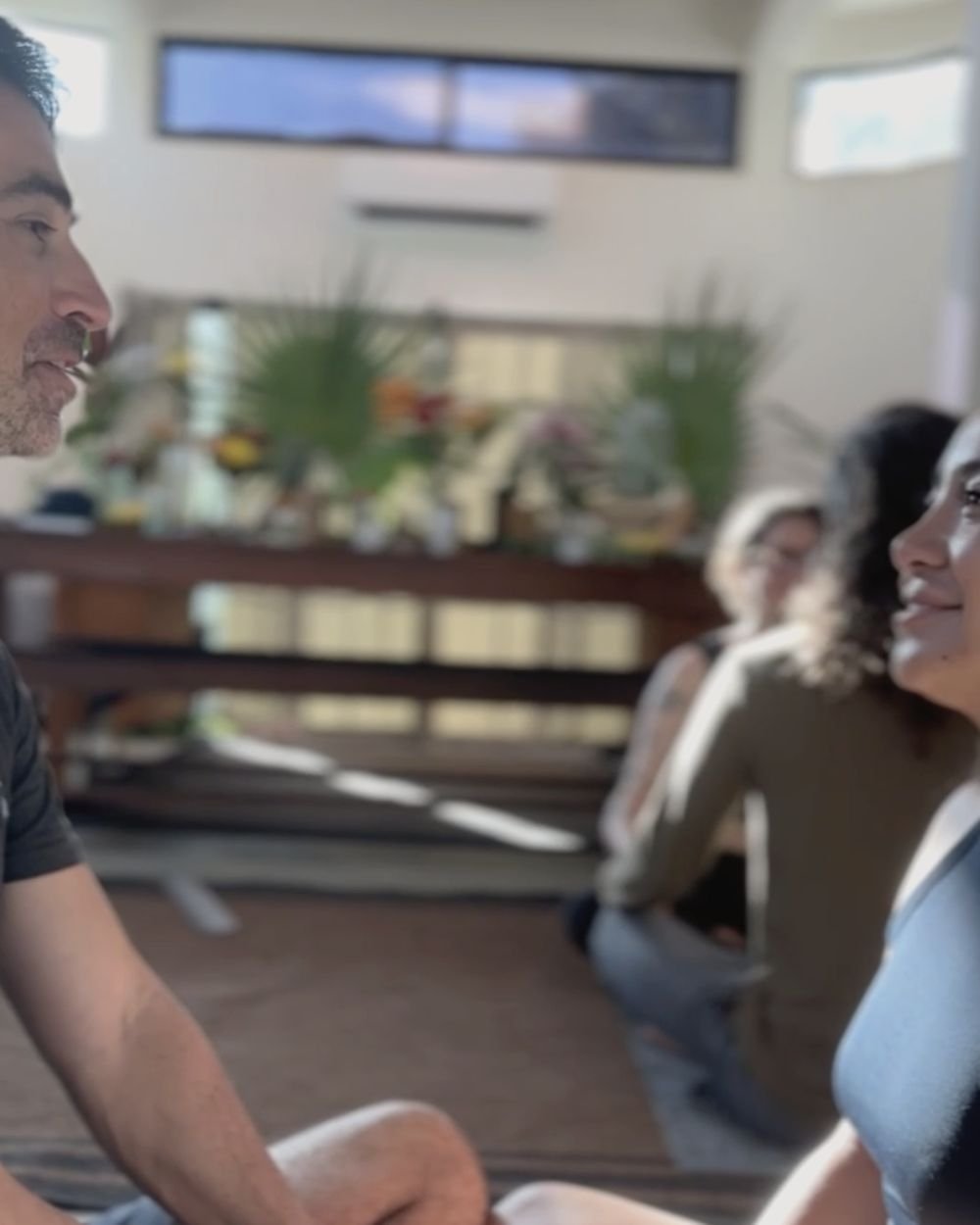 Two retreat participants in an eye gazing connection exercise at Rancho Verde Tulum