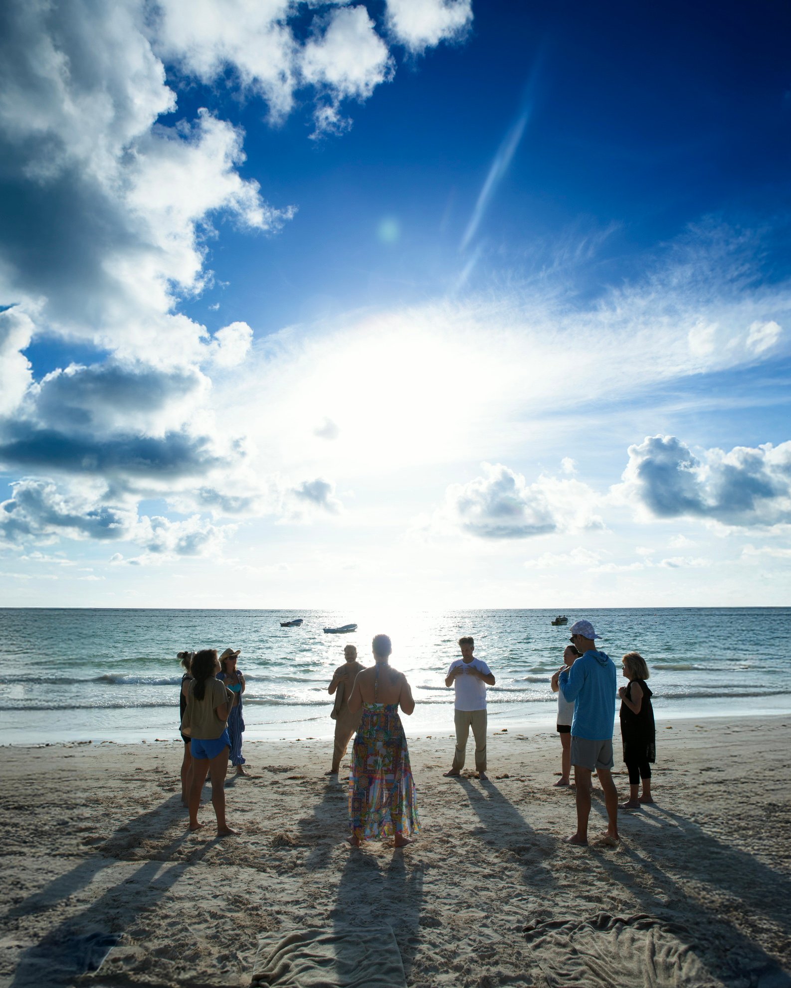 Sunrise beach ceremony circle with retreat guests at Purpose Reset Retreat, Tulum