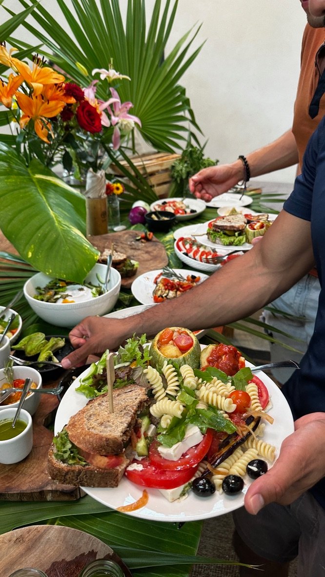 Guest plating a vegan lunch buffet at Purpose Reset Retreat Tulum