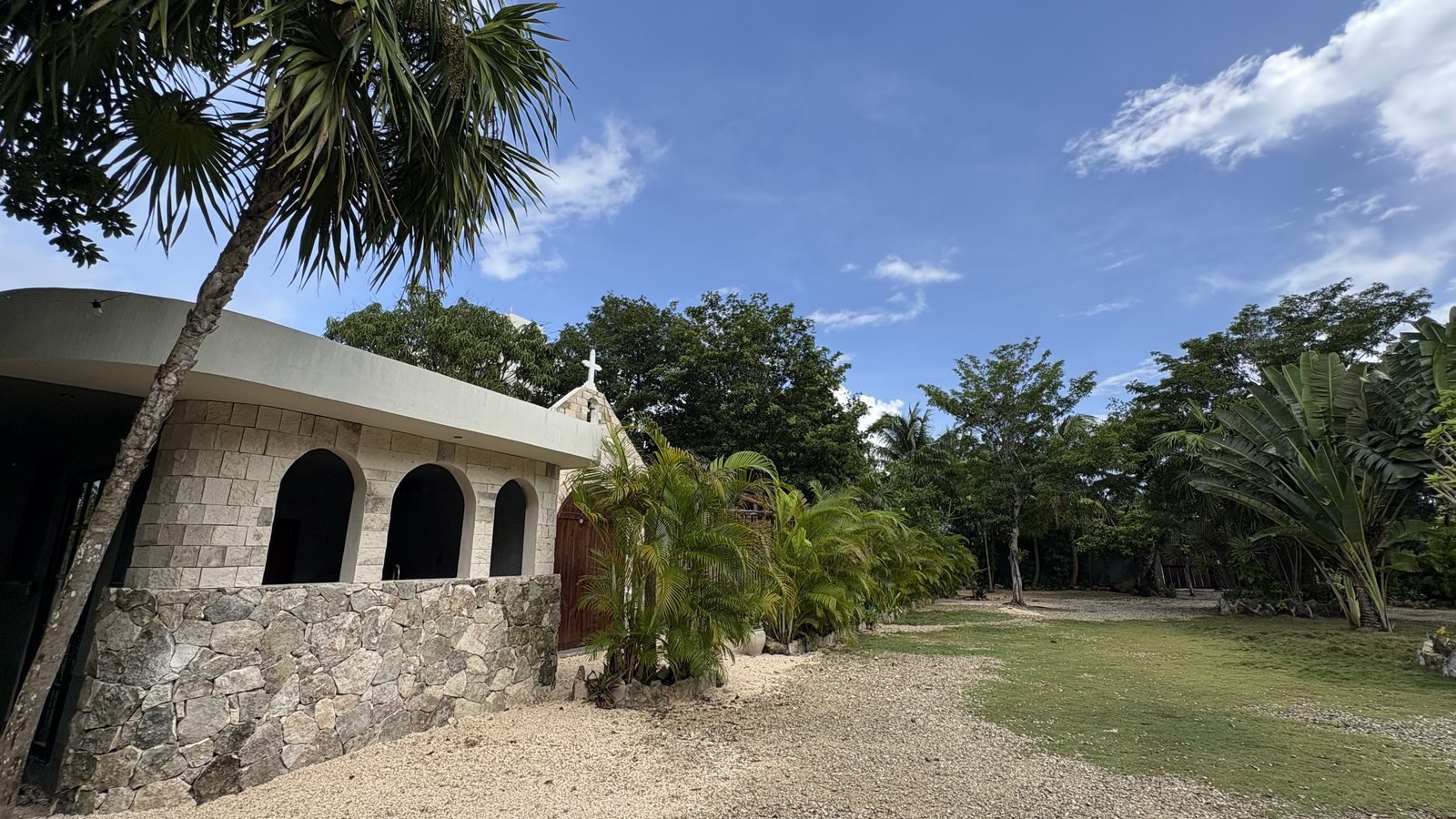 Arched stone exterior and lawn beside the Chapel, The Chapel, Airbnb at Rancho Verde Tulum