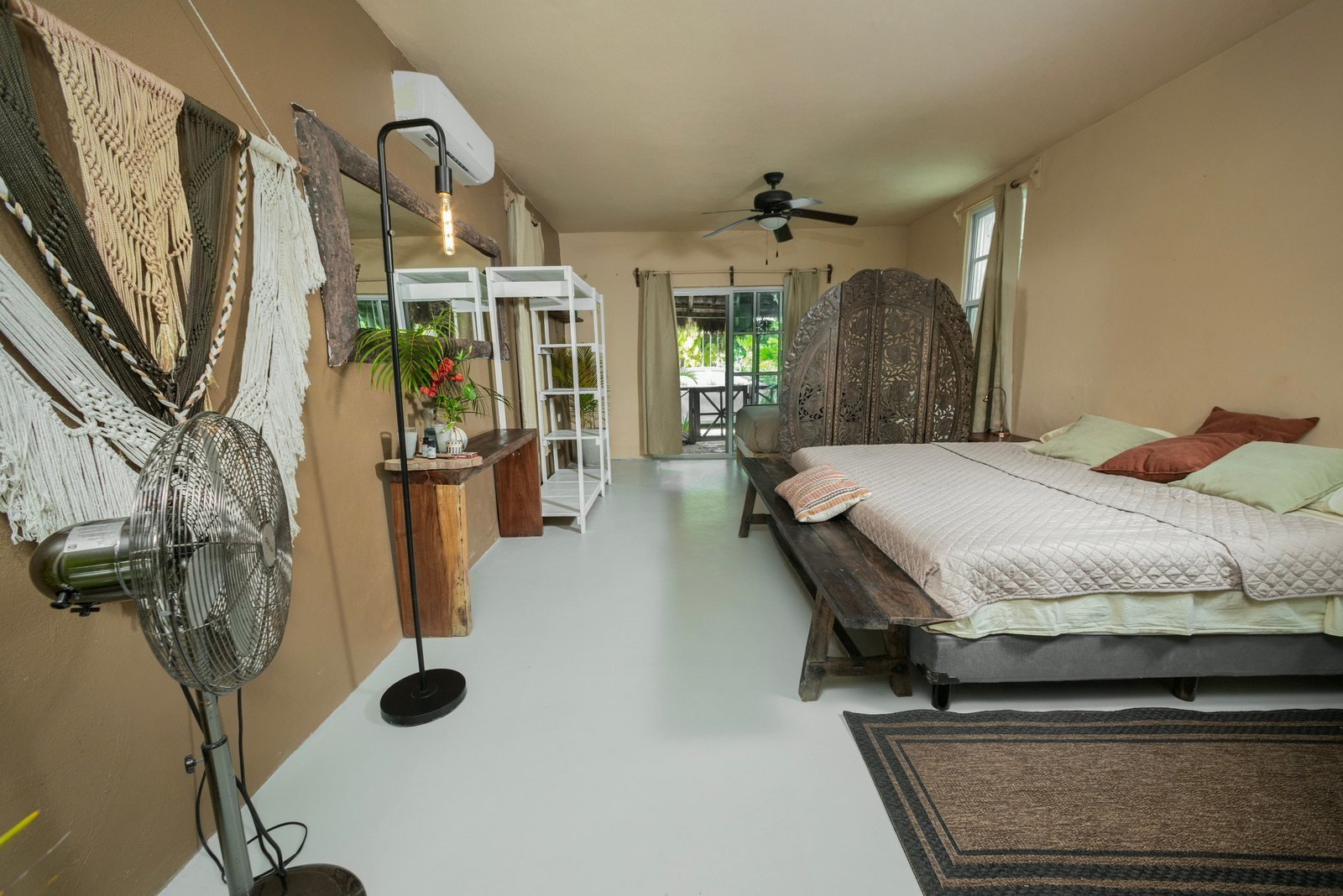 Bedroom with carved wooden screen and ceiling fan, The Chapel, Airbnb at Rancho Verde Tulum