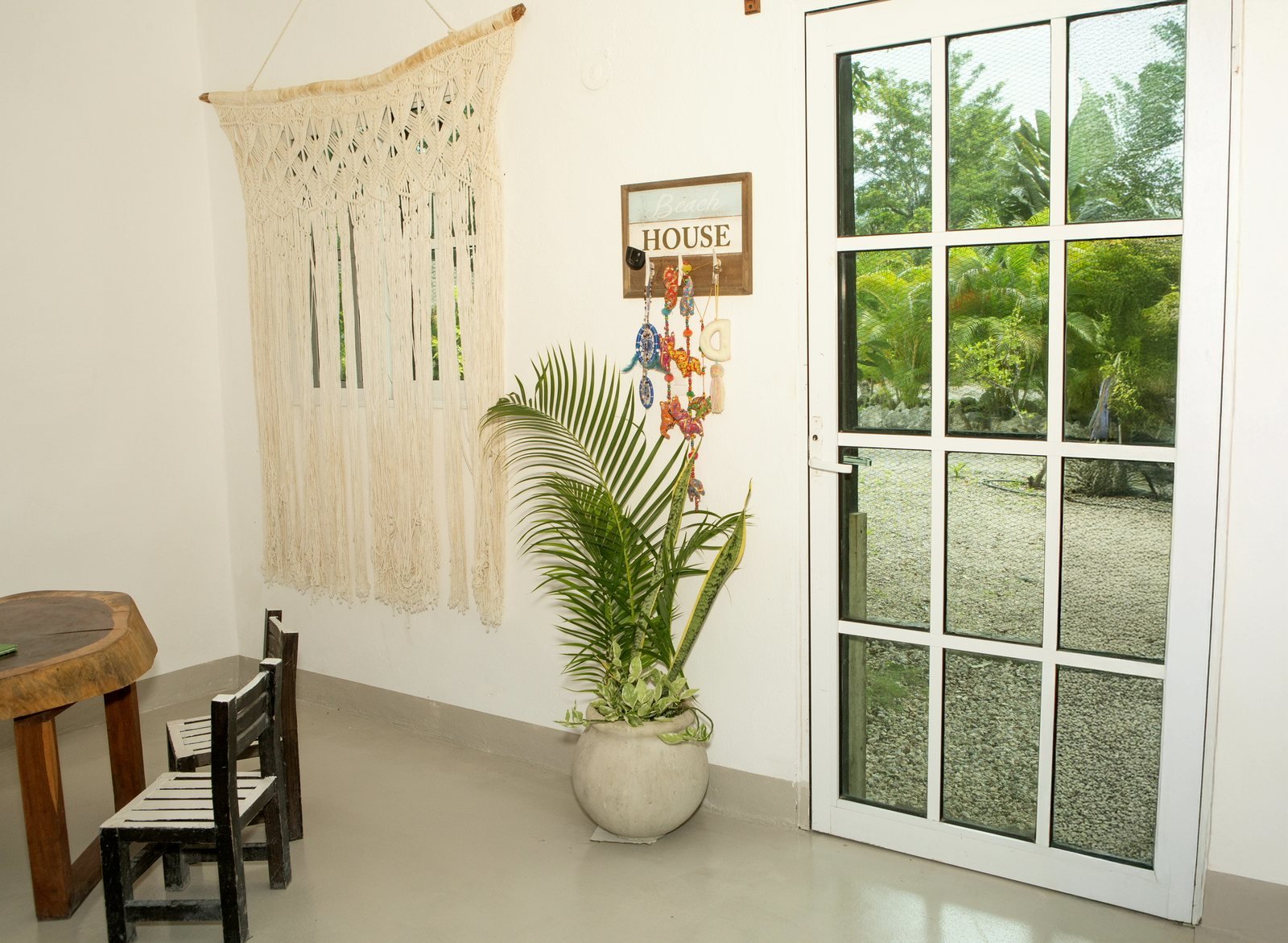 Bedroom with woven headboard and a garden door, The Family House, Airbnb at Rancho Verde Tulum