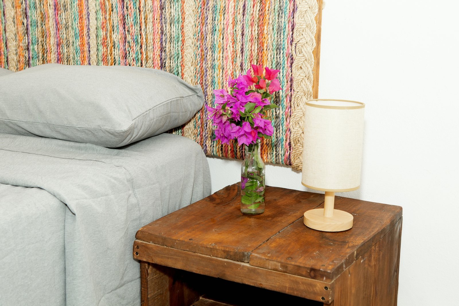Bedside table with bougainvillea and linen lamp, The Family House, Airbnb at Rancho Verde Tulum