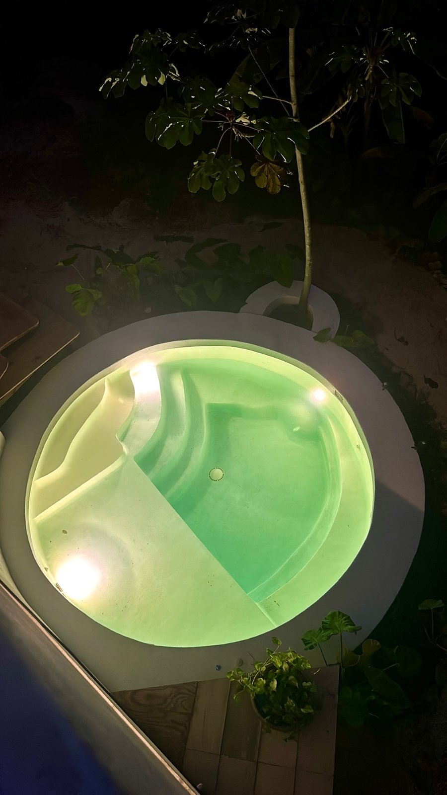 Round plunge pool lit up at night, Airbnb at Rancho Verde Tulum