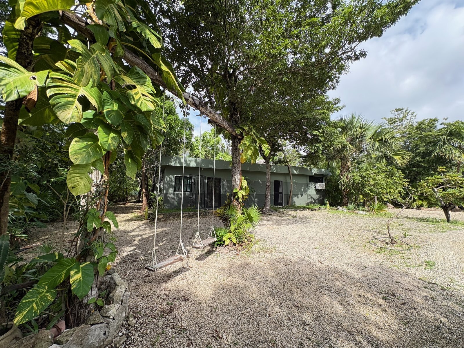 Green exterior with rope swings under the trees, The Studio w. Bathroom, Airbnb at Rancho Verde Tulum