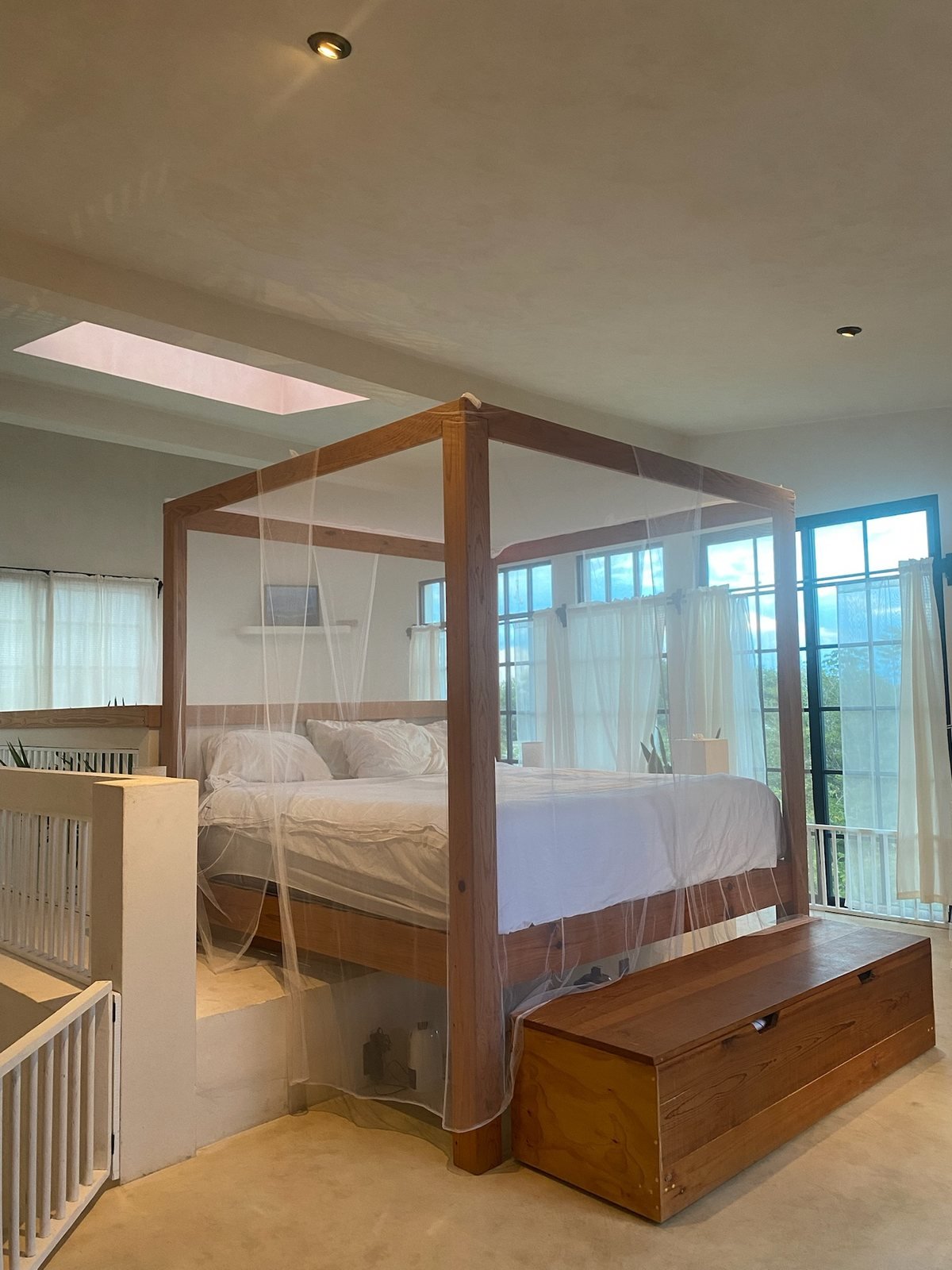 King-size canopy bed with mosquito net and garden-view windows, The Villa, Airbnb at Rancho Verde Tulum