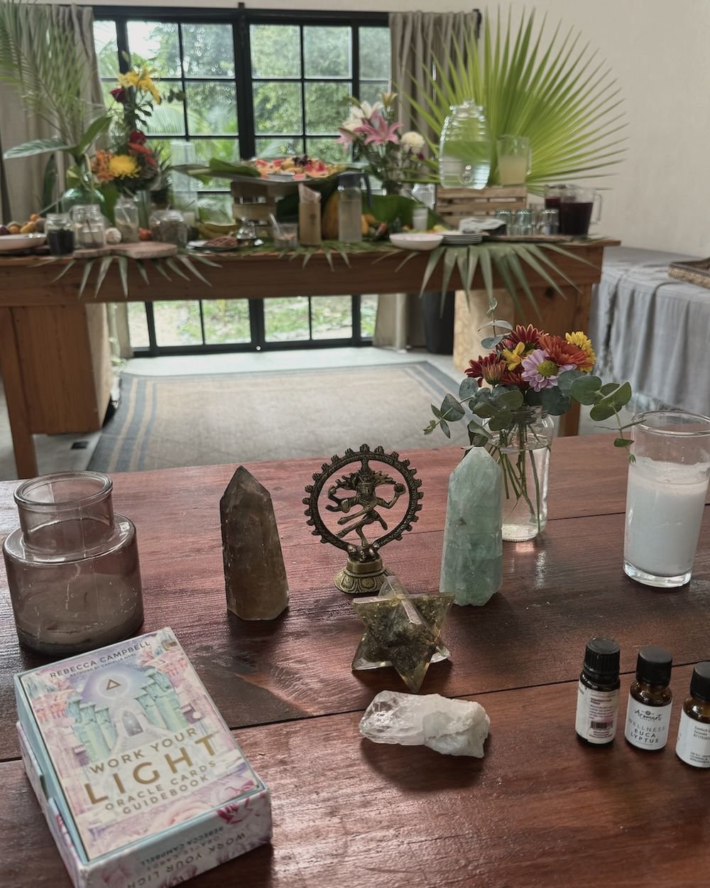 Intention altar with crystals, oracle cards and a plant-based breakfast table at a Rancho Verde Tulum retreat