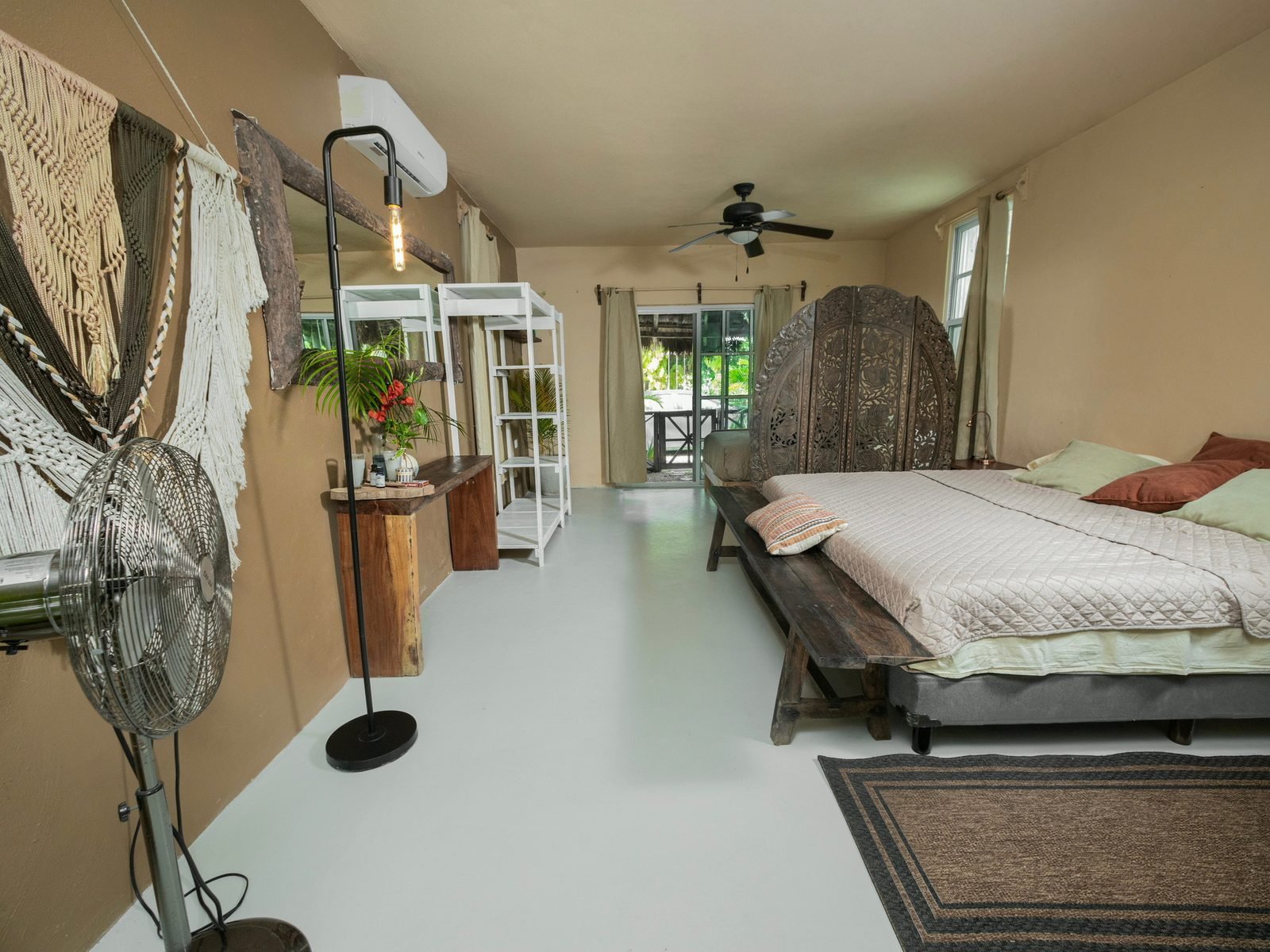 Private studio with king bed, macrame wall art and a sliding door to the garden, Premium package, Purpose Reset Retreat at Rancho Verde Tulum
