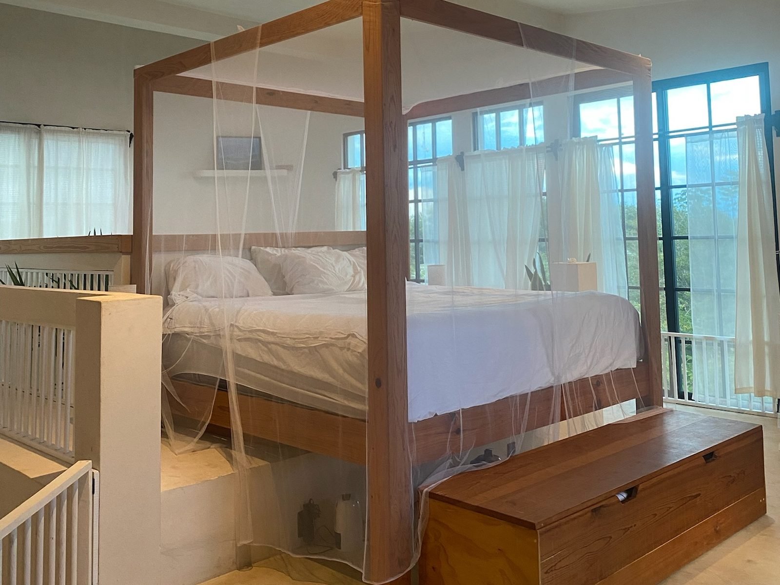 Private suite with a wooden canopy bed, mosquito net and jungle-view windows, Solitude package, Purpose Reset Retreat at Rancho Verde Tulum