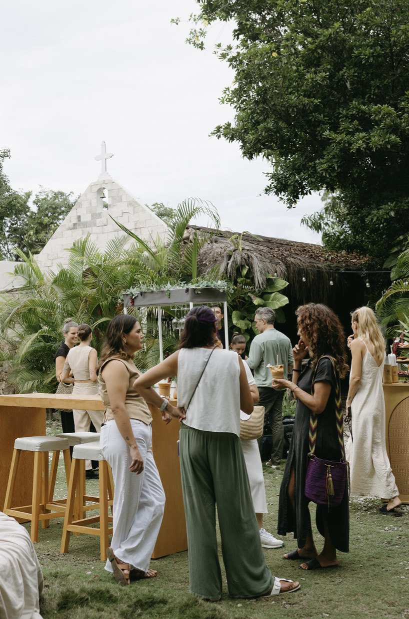 Wedding guests mingling at the cocktail bar beside the chapel at Rancho Verde Tulum